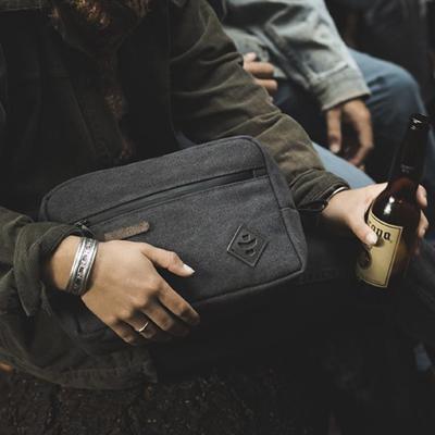 Person holding a pipe pouch