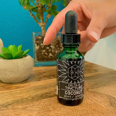 Hi On Nature product image on a wooden surface with a blue background with plants