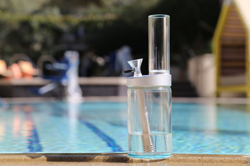  clear glass bong with downstem beside pool 