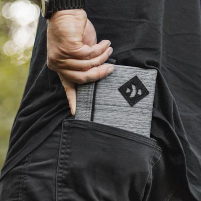 Person putting smell-proof wallet in their pocket