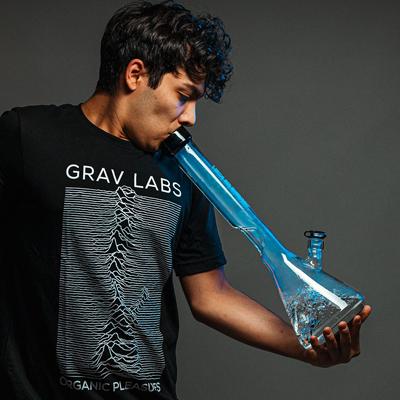 Person smoking a tall blue Grav Labs bong